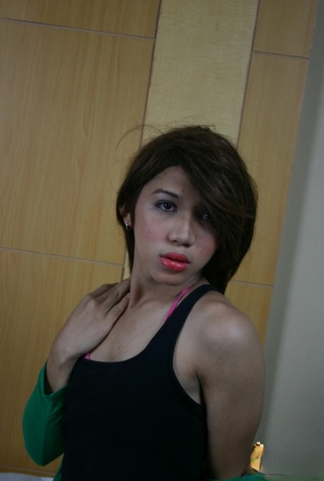 Brunette Asian shemale Emocute undressing and masturbating in fishnets
