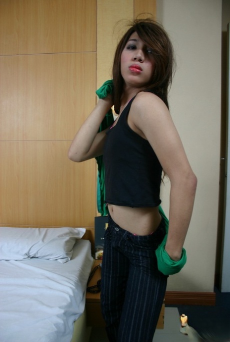 Brunette Asian shemale Emocute undressing and masturbating in fishnets