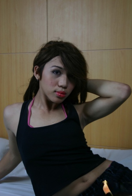 Brunette Asian shemale Emocute undressing and masturbating in fishnets