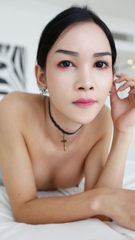 Slim Asian shemale doffs her black undies & pulls out her big dick before sex